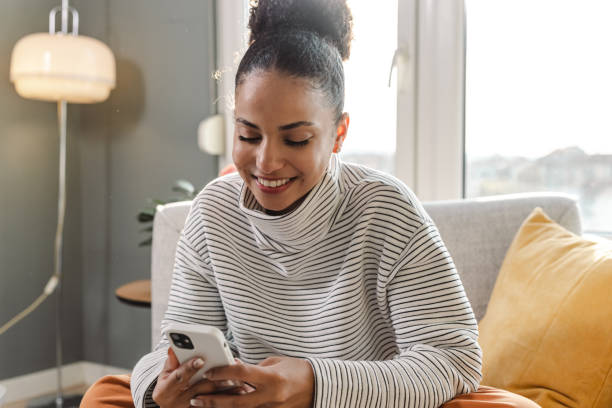 istock Young woman relaxing at home and using social media 1436376109