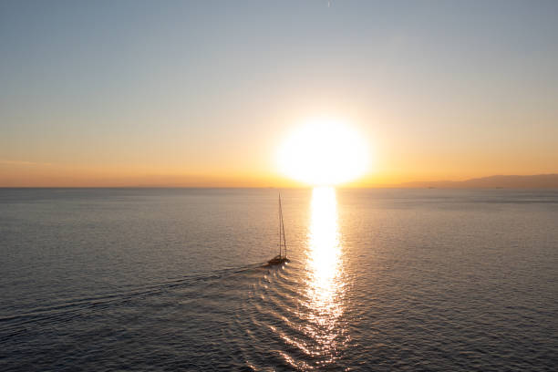 ボートは日没に航海する - ligurian sea ストックフォトと画像