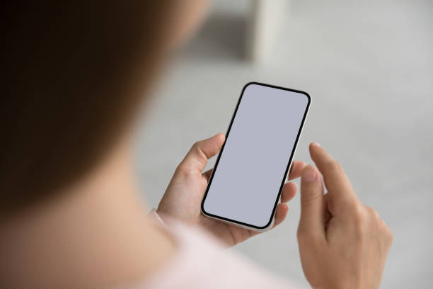 istock Unknown woman holds smartphone with white mock up screen view 1436376648