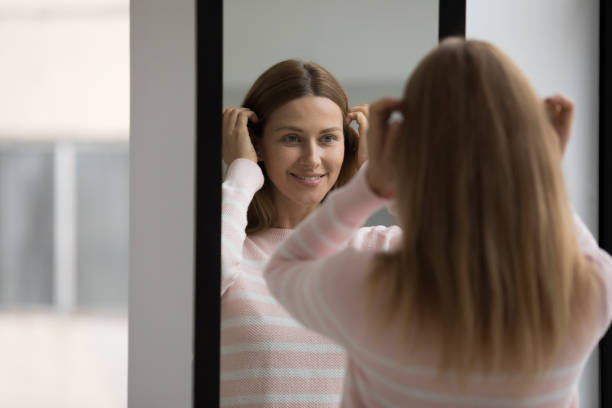istock Woman preening, do morning routine, standing in front of mirror 1436376731