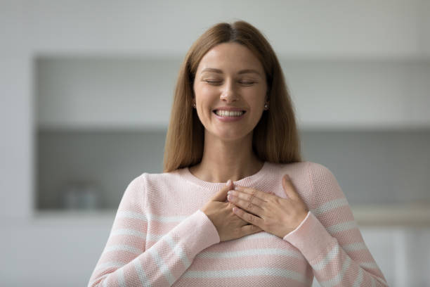 istock Headshot portrait young woman holding folded hands on chest 1436377630