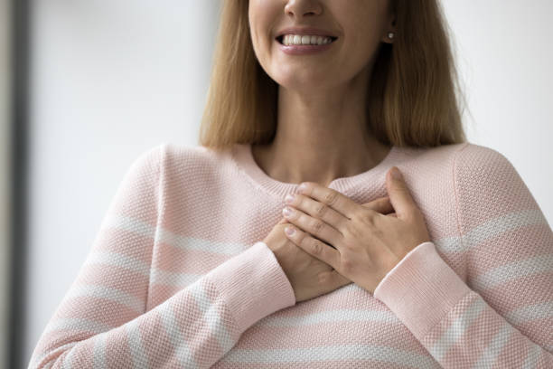 istock Sincere woman express gratitude with folded hands on chest, closeup 1436377642