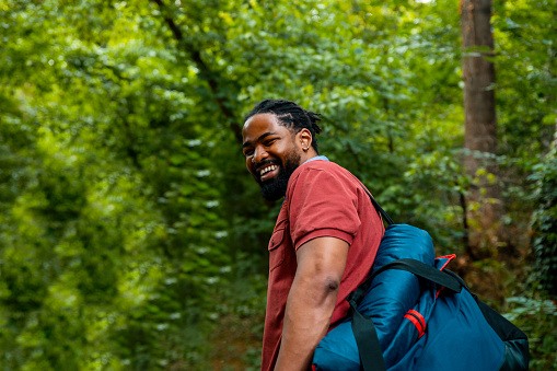 Happy of male hiker enjoying in walk in the Green forest. Copy space