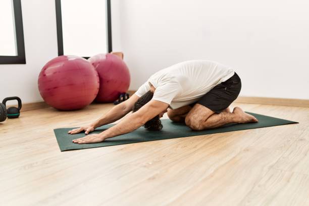 istock Young hispanic man stretching at sport center 1436378718