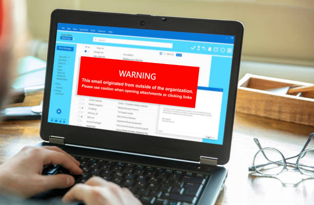 Email attachments warning message on a laptop screen. Computer Virus and Antivirus. stock photo