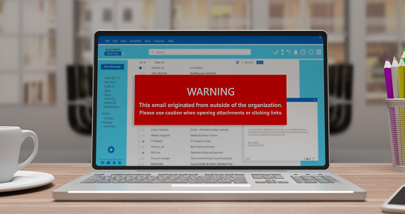 Cyber security concept. Email warning message on a laptop screen. Caution with opening attachments and clicking links.  3d render