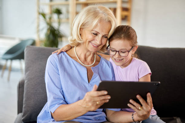 istock Grandma and granddaughter with digital tablet 1436380649