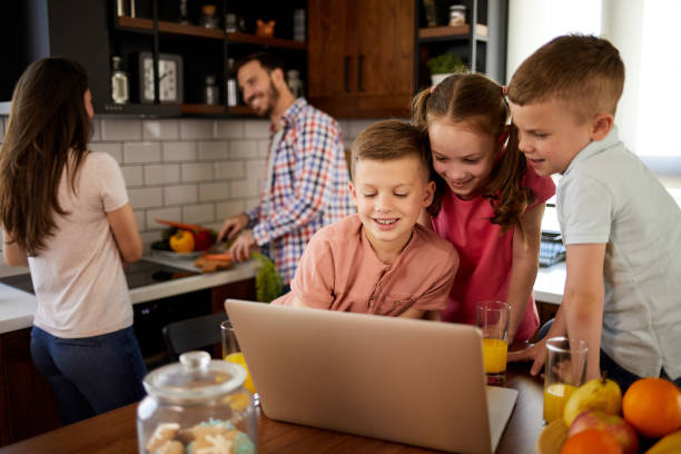 istock Children surfing the internet using laptop while having breakfast at home 1436380949