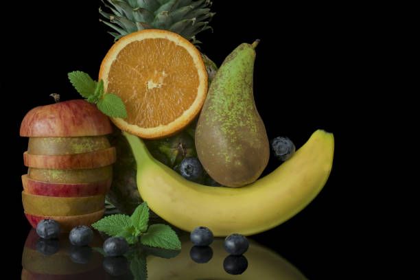 istock Red apple with pear ,banana,pineapple,black background 1436382860
