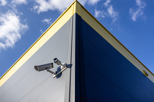 Surveillance camera on wall of building