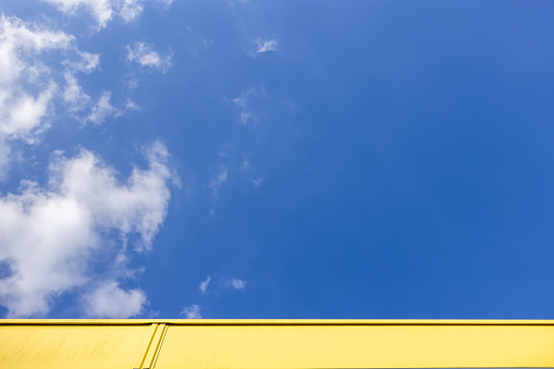 Yellow part of building and blue sky