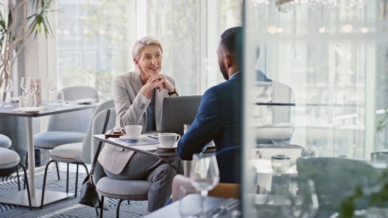 Business meeting, consulting or woman recruitment leader coaching employee or corporate worker in restaurant. Communication, hiring or interview in cafe for management, businessman or job interview.