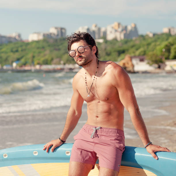 istock Young surfer man sit on a surfboard 1436387288
