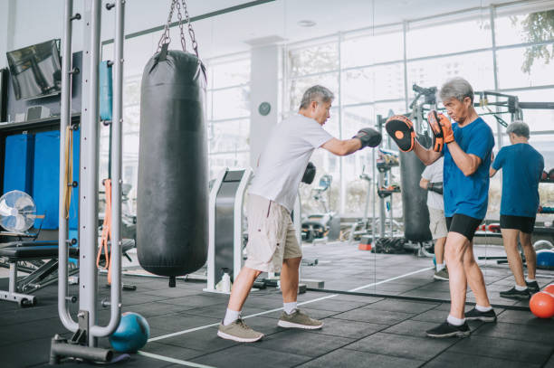 istock Asian Chinese Senior Men practicing boxing sparring in gym on routine weekend activity 1436388496