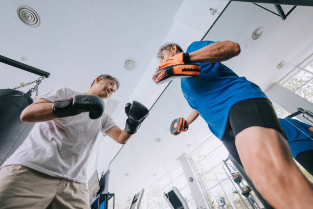 istock Asian Chinese Senior Men practicing boxing sparring in gym on routine weekend activity 1436388509
