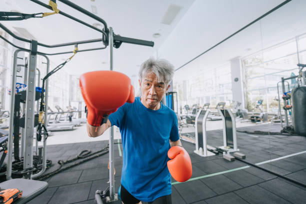 point of view chinese senior man practicing boxing in gym