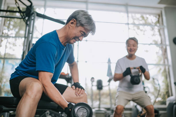 istock 2 active Chinese senior men workout in gym with kettlebell and dumbbell strength training 1436388644