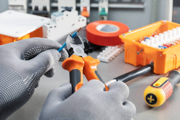 istock Electrician working with wire and electrical equipments. Home improvement, repair electrical power system. 1436388872