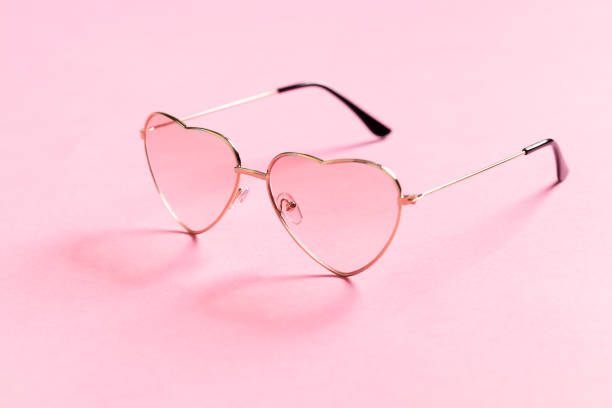 istock Heart shape sunglasses on pink background 1436389041