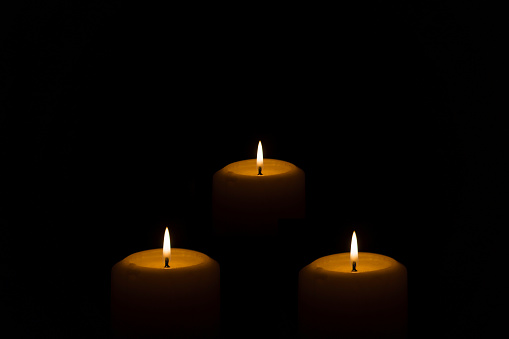 Flame candles isolated on black background. Close up.