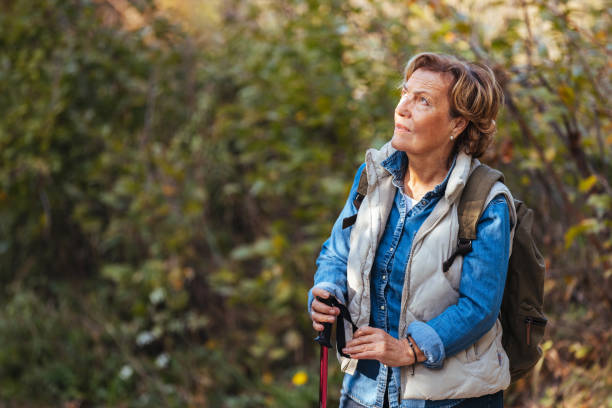 istock Senior woman with backpack hiking on sunny day 1436391221