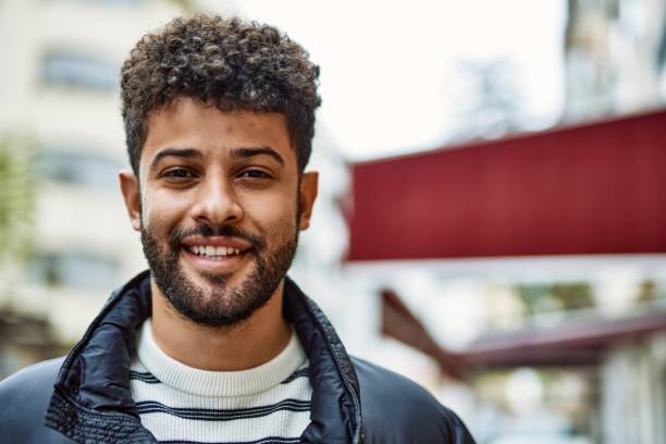istock Young   man smiling outdoor at the town 1436391416