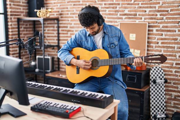 istock Young   man musician playing classical guitar at music studio 1436391432