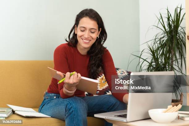 Happy Girl Freelancing At Her Living Room Stock Photo - Download Image Now - 25-29 Years, Adult, Adult Student