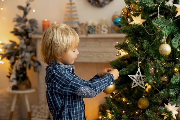 Cute child, boy, playing in a decorated room for Christmas