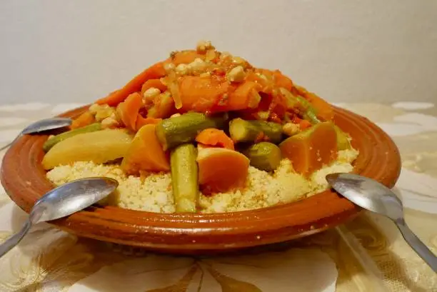 Photo of Close up of delicious homemade couscous at Moroccan home. Marrakech, Morocco.