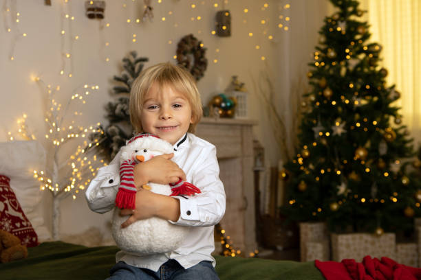 Cute child, boy, playing in a decorated room for Christmas