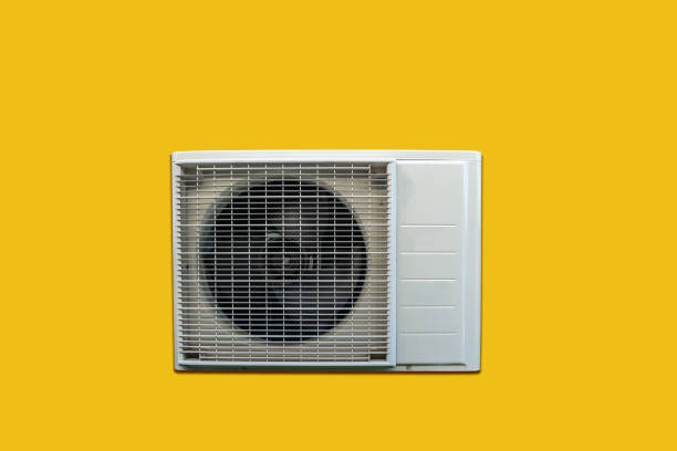 istock Heat pump outdoor unit isolated on yellow background. 1436395784