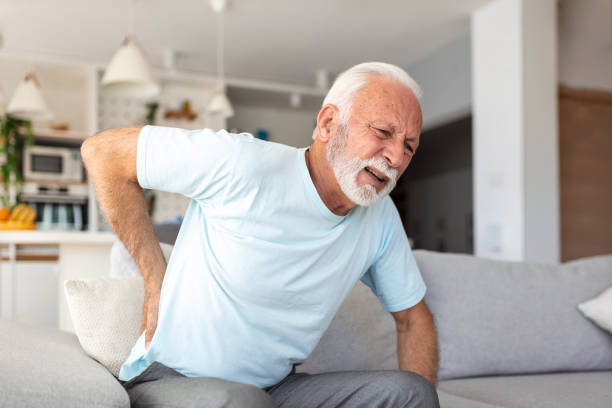istock Senior elderly man touching his back, suffering from backpain, sciatica, sedentary lifestyle concept. Spine health problems. Healthcare, insurance 1436396170