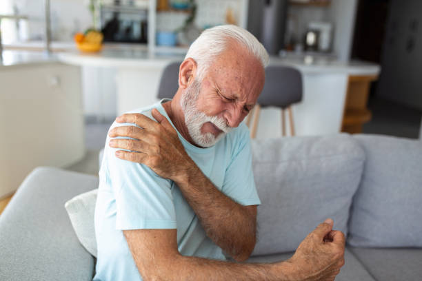 istock Senior elderly man touching his shoulder, suffering from shoulder pain, sciatica, sedentary lifestyle concept. shoulder health problems. Healthcare, insurance 1436396171