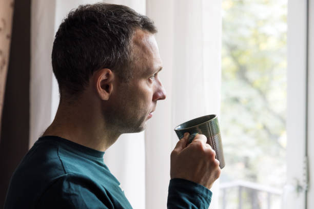 Profile portrait of young adult Caucasian man with coffee stock photo