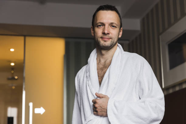 istock Smiling young Caucasian man in white cotton bathrobe 1436398836
