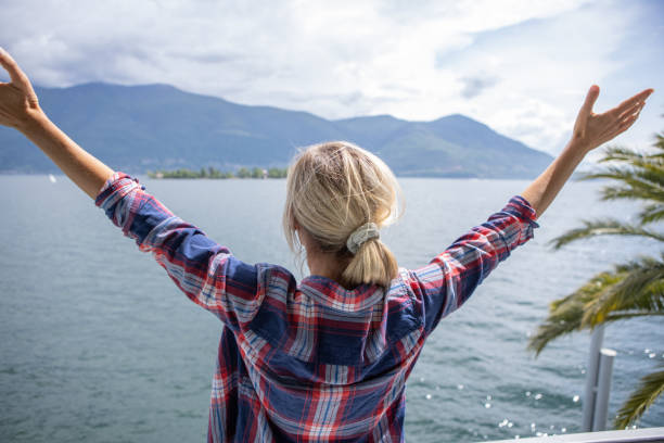 istock Woman outstretching arms on balcony 1436401255