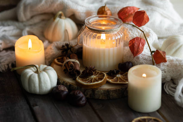 istock Autumn home composition with aromatic candle, dry citrus, cinnamon, anise. Aromatherapy on a grey fall morning, atmosphere of cosiness and relax. Wooden background close up 1436402616