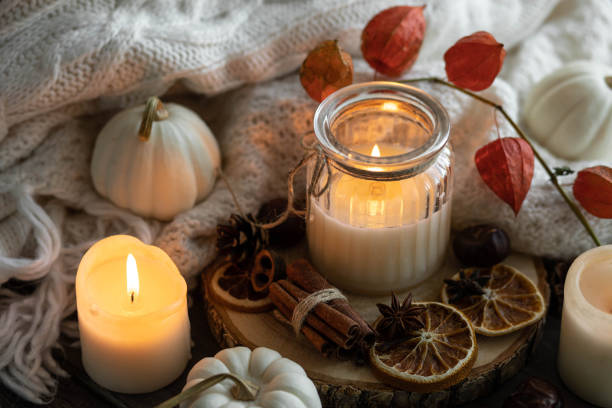 istock Autumn home composition with aromatic candle, dry citrus, cinnamon, anise. Aromatherapy on a grey fall morning, atmosphere of cosiness and relax. Wooden background close up 1436402636