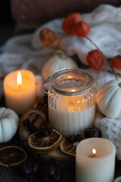 istock Autumn home composition with aromatic candle, dry citrus, cinnamon, anise. Aromatherapy on a grey fall morning, atmosphere of cosiness and relax. Wooden background close up 1436402640