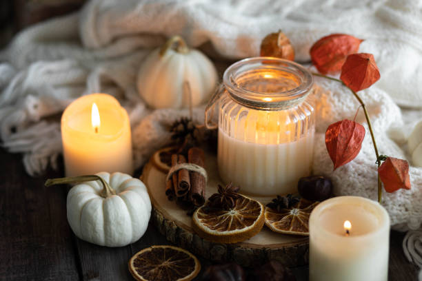 istock Autumn home composition with aromatic candle, dry citrus, cinnamon, anise. Aromatherapy on a grey fall morning, atmosphere of cosiness and relax. Wooden background close up 1436402657