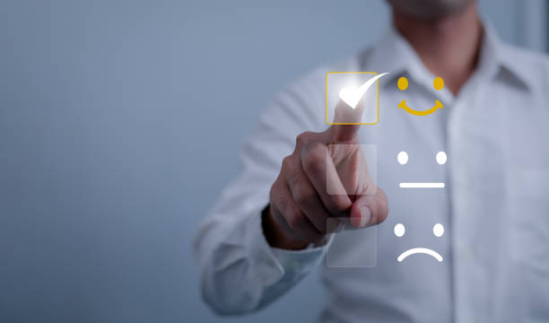Customer service and Satisfaction concept ,Business people are touching the virtual screen on the happy Smiley face icon to give satisfaction in service. rating very impressed.