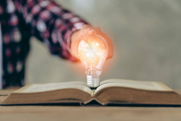 istock Hand holding a light bulb with innovative and creative ideas. energy and money saving ideas 1436409536