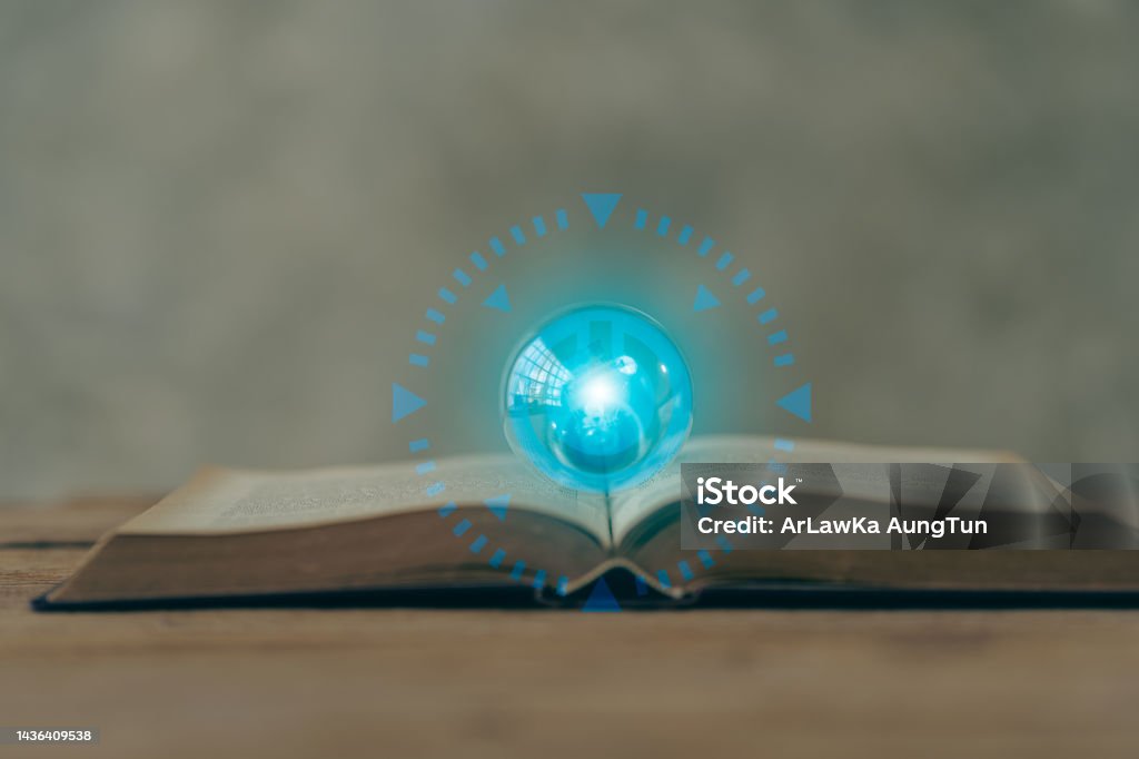 world of learning books on table with blue light bulb and unlock icon Back to School Stock Photo