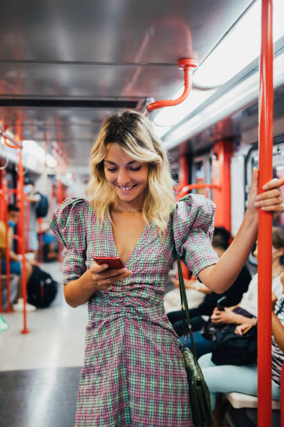 istock A Happy Beautiful Businesswoman Texting On Her Mobile Phone While Standing In The Underground Train 1436412251