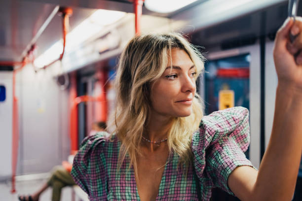 istock A Happy Beautiful Woman Looking Away While Standing In The Underground Train 1436412293