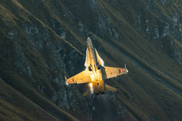 istock F/A18 jet fighter flying in the mountain 1436413268