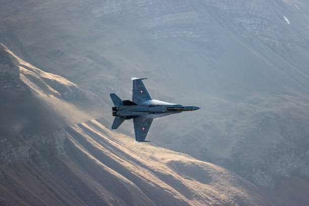 istock F/A18 jet fighter flying in the mountain 1436413297