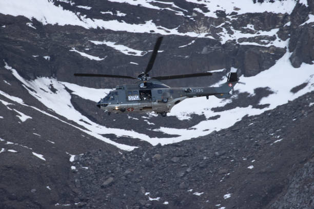 istock Eurocopter super puma flying in Alps 1436413431