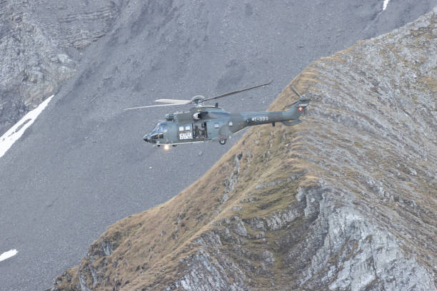 istock Eurocopter super puma flying in Alps 1436413461